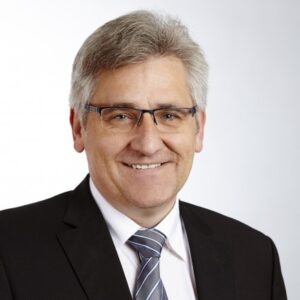 A portrait photo of a smiling Manfred Schleicher, Vice President Element Logic DACH