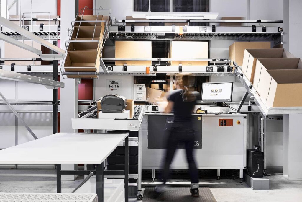 Warehouse worker at AutoStore picking station