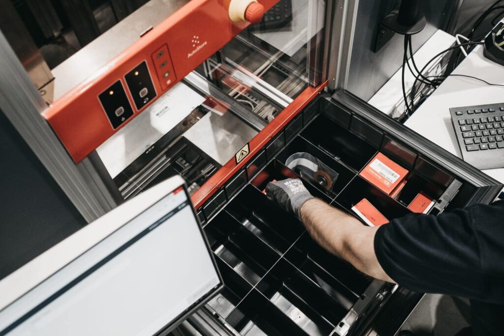 Warehouse worker at AutoStore Picking Station at Bertel O. Steen