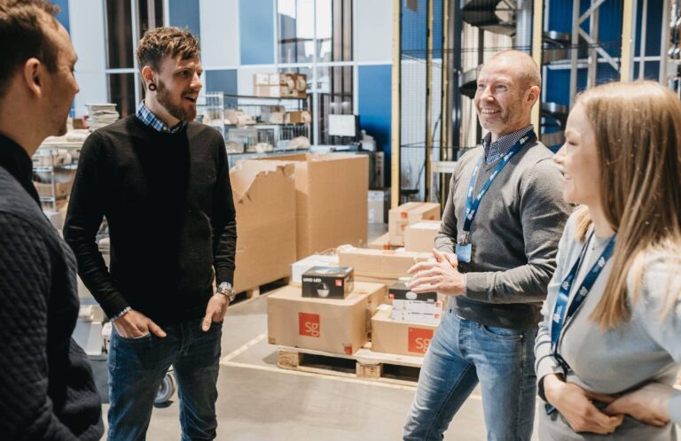 Berggaard Amundsen employees talking to Element Logic employees inside the warehouse