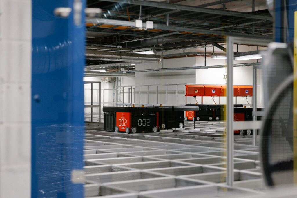 The TRN AutoStore with robots working and collecting bins.