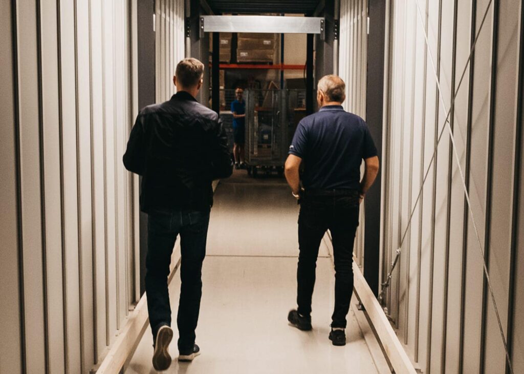 Co-founder, Trond Gule, and Element Logic Sales Manager, Øyvind Kollerud, walking through the custom-made tunnel through AutoStore in GS Bildeler Oslo warehouse