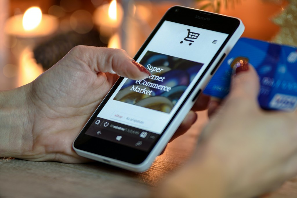 Person holding a phone and a credit card