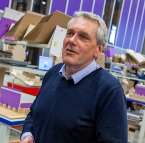 Man in front of automated warehouse