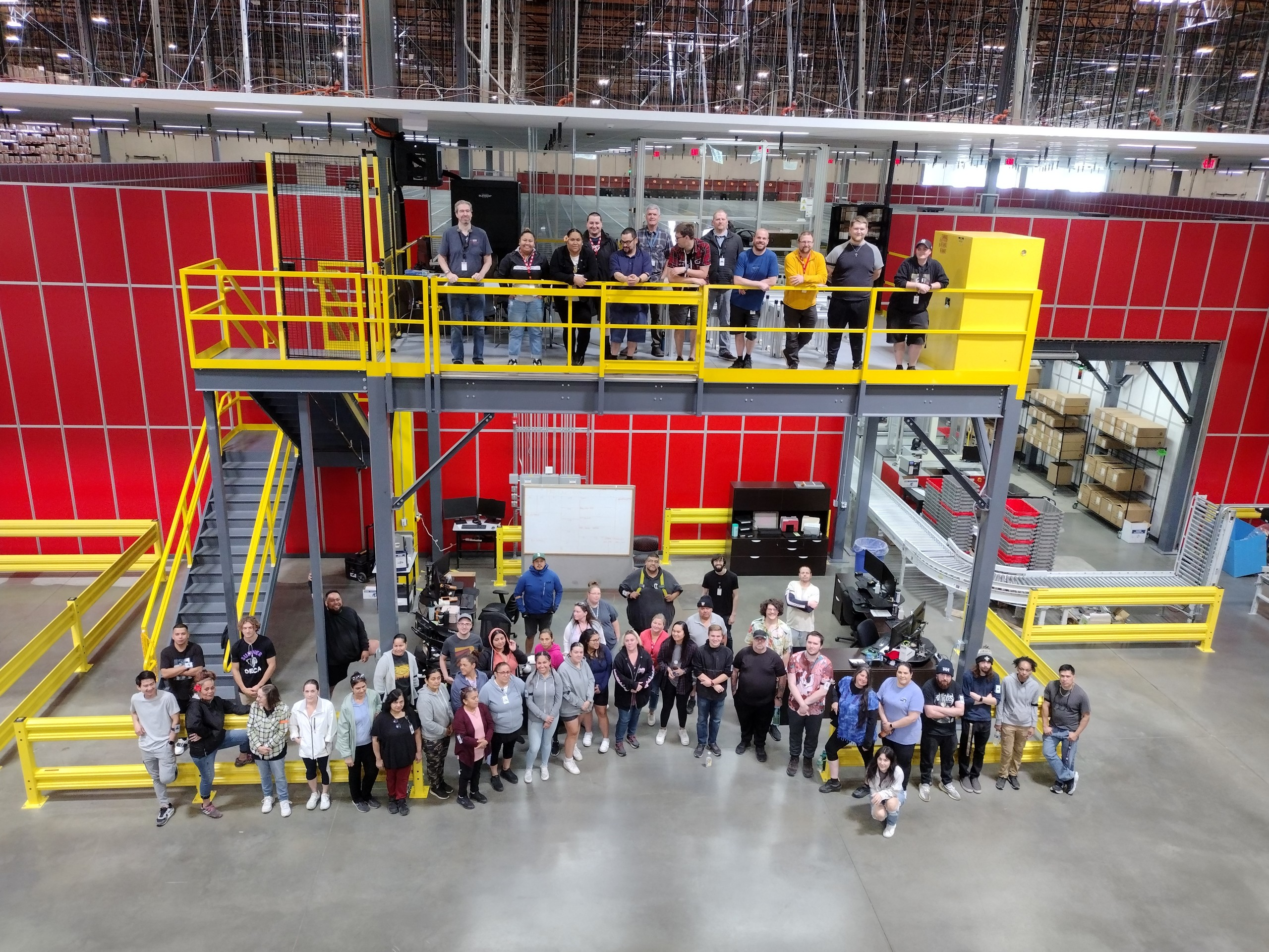 Many people standing at an automated warehouse