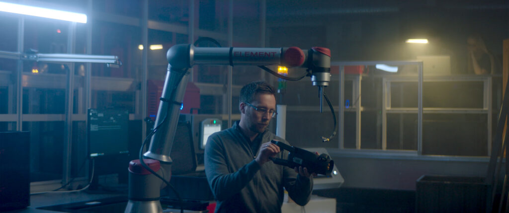 A picture of someone working on a robotic arm